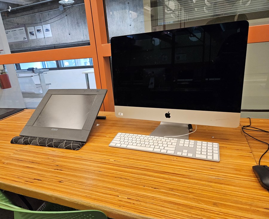 Close view of a computer lab station equipped with a Wacom drawing tablet.