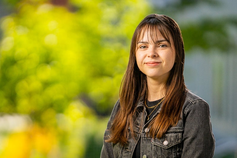 woman with long brown hair wearing a black denim jacket