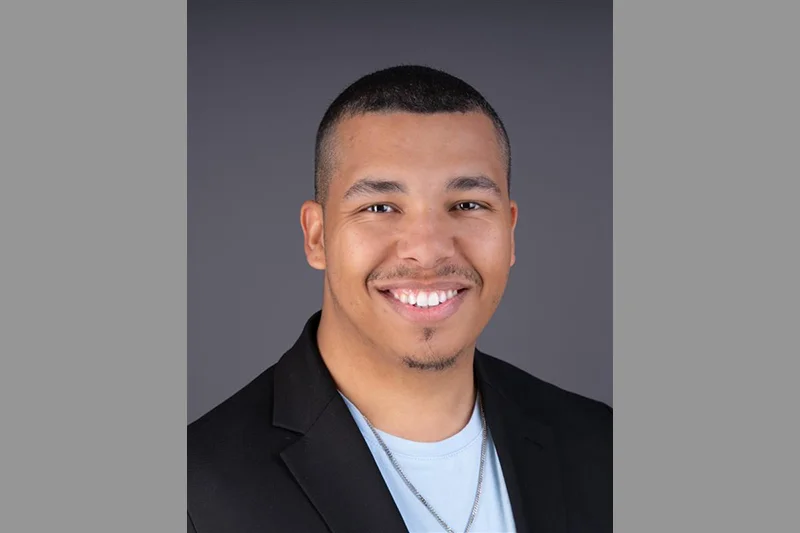 Smiling man with short black hair