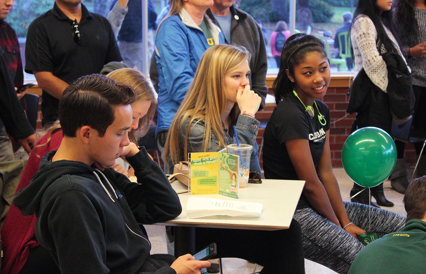Students gathered together and having a good time in the Fish Bowl.