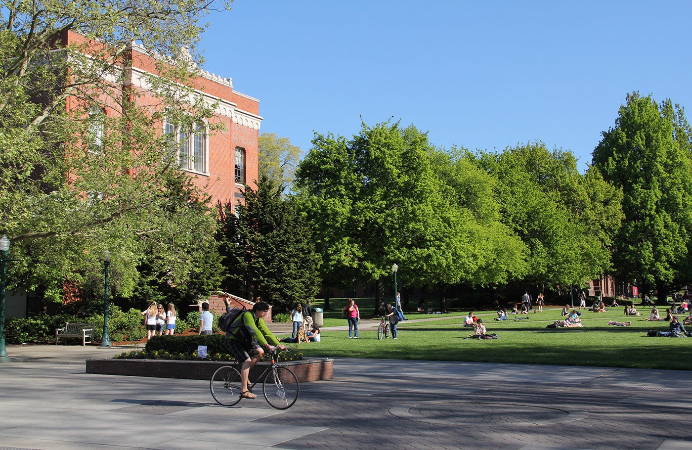 Student riding on bike down 13th avenue.